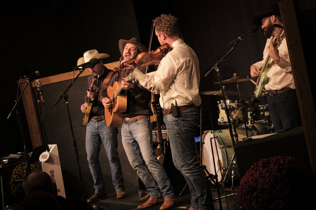 Guitar, fiddle and bass playing together up close